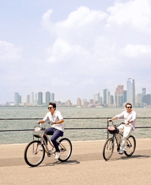 Two friends biking on the waterfront